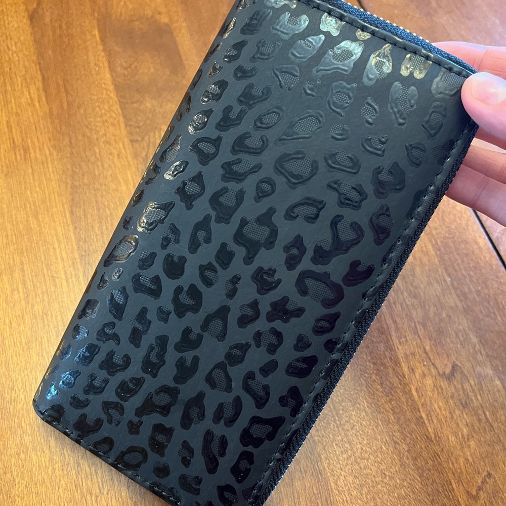 Black “leopard” print zippered wallet.